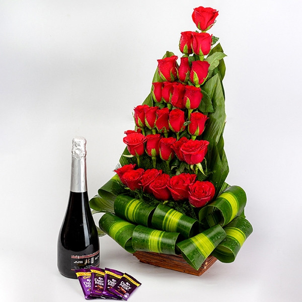 Combo Of Basket Arrangement Of 27 Red Roses With Fruit Champagne And 4 Dairy Milk Chocolate