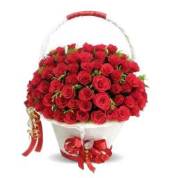 A White Basket Container Of 70 Red Roses